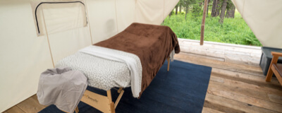 A massage bed inside a wall tent at Minam River Lodge